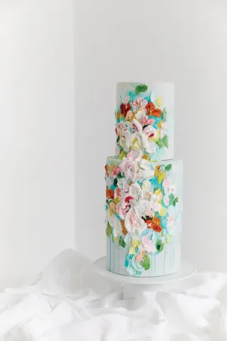 Modern wedding cake with artistic splashes of color in bright, floral hues.